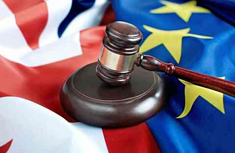 Gavel sat on union jack and eu flags