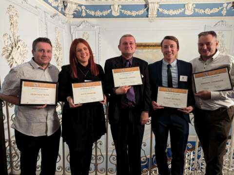 People proudly holding their advanced milling diploma certificates