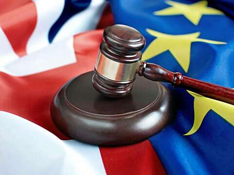 Gavel sat on union jack and eu flags