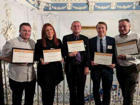 People proudly holding their advanced milling diploma certificates