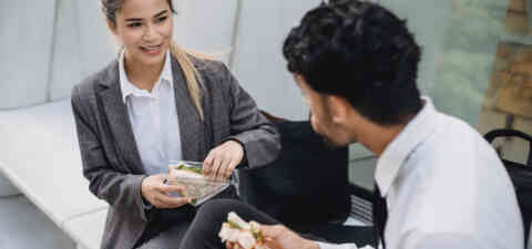 Adults eating sandwiches