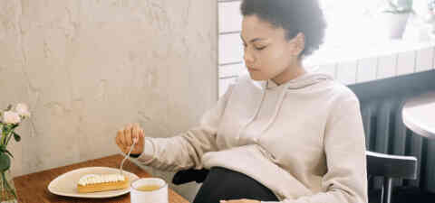 Pregnant woman eating dessert