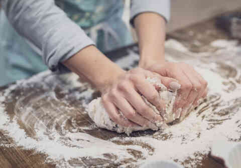 Woman kneading bread dough